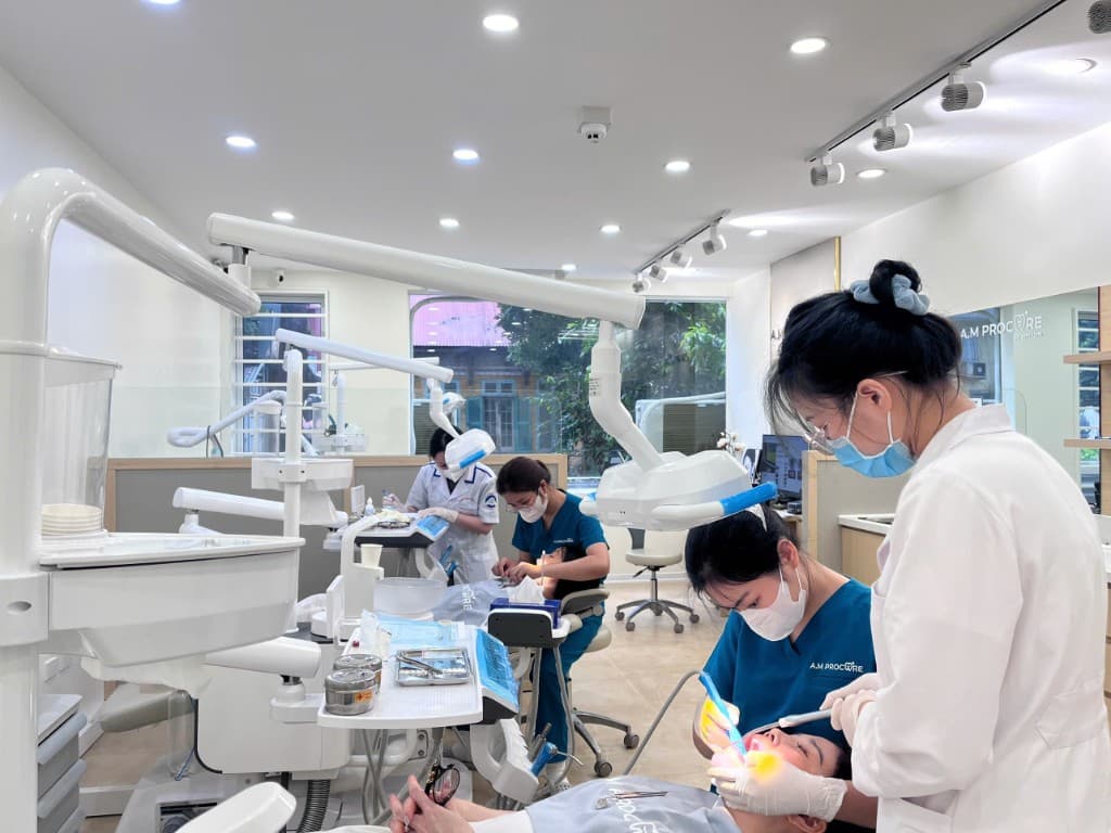 Bright modern dental treatment floor with multiple chairs and clinical team at Hanoi International Dental Center