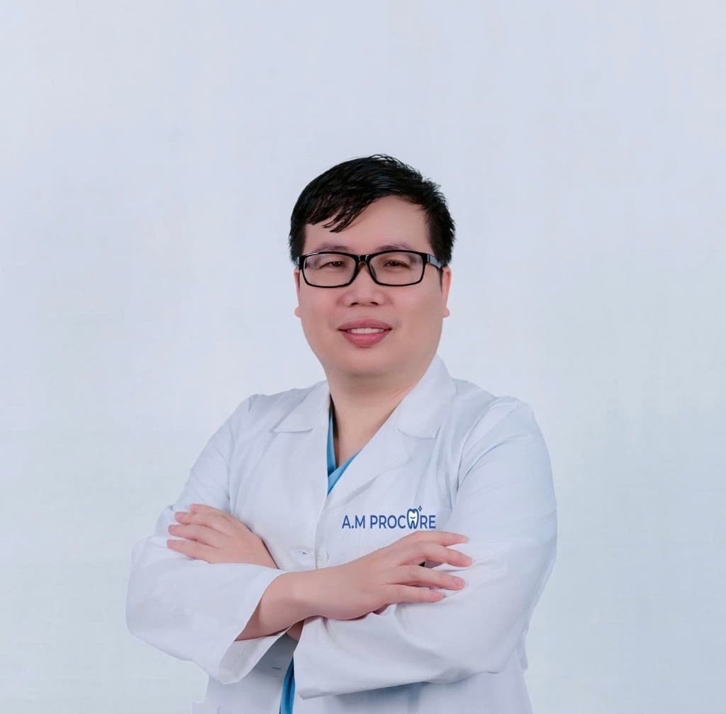 Portrait of a male dentist in a white clinical coat — Hanoi Dental Travel team.